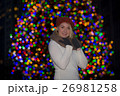 Beautiful young woman with christmas tree in the background 26981258