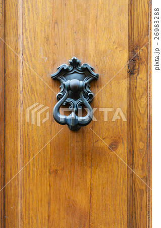 bronze knocker on old wooden door in Florence 26983288