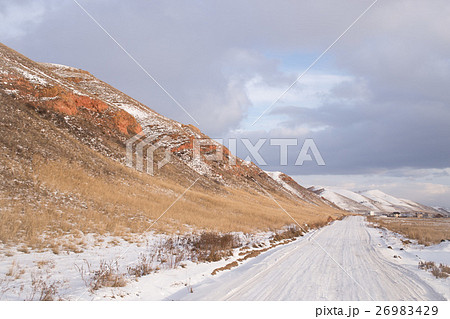 Winter snowy road along the mountains 26983429