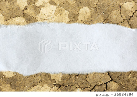 Ragged piece of paper on cracked soil 26984294