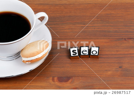 Coffee cup on a wooden table and text - SEO Coffee cup on a wooden table and text - SEO 26987517