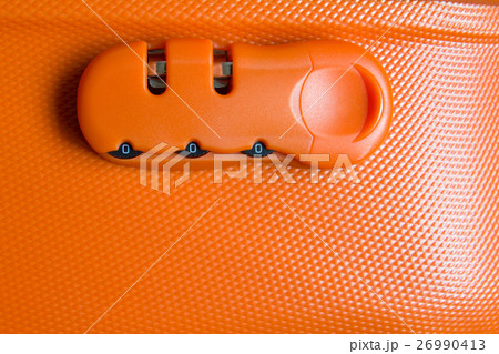 Password lock of orange luggage background Password lock of orange luggage background 26990413