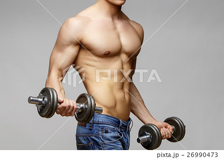 Shirtless bodybuilder holding dumbell and showing 26990473