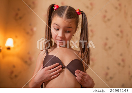 Little girl try on mothers underwear. Little girl try on mothers underwear. 26992143