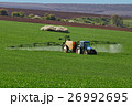 Tractor spraying field, rural landscape in country 26992695