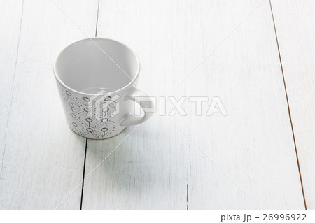 Green pattern cup on white wooden background 26996922