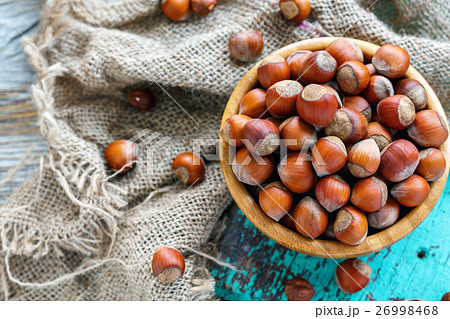Full bowl of hazelnut and old burlap closeup. 26998468