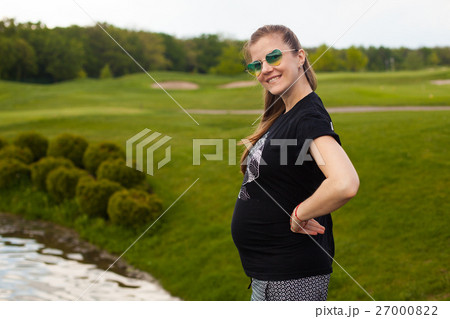 Young pregnant woman in nature 27000822