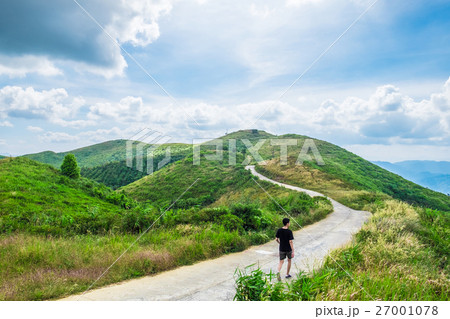 Man walking road way curve on mountain 27001078