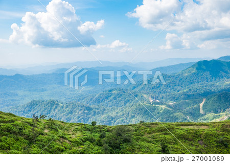Green mountain peak slope bright sky 27001089