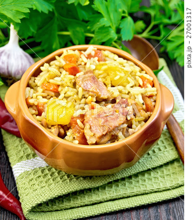 Rice with chicken and zucchini in clay bowl 27001317