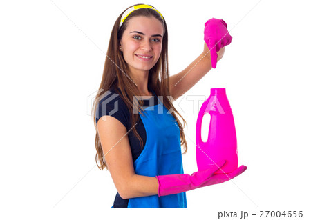 Woman in apron holding a detergent Woman in apron holding a detergent 27004656