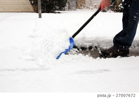 Man shoveling and removing snow of his house Man shoveling and removing snow of his house 27007672
