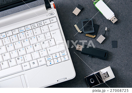 White laptop with different kinds of data carrier 27008725