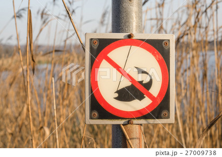 No fishing sign on a post by a river 27009738
