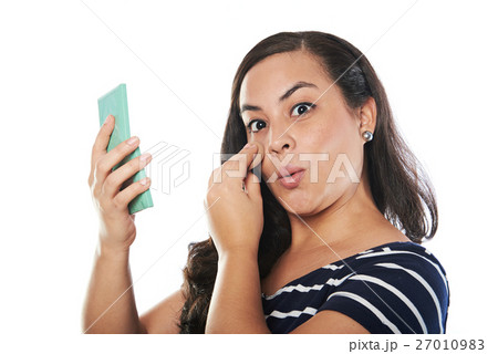young woman putting cosmetic young woman putting cosmetic 27010983