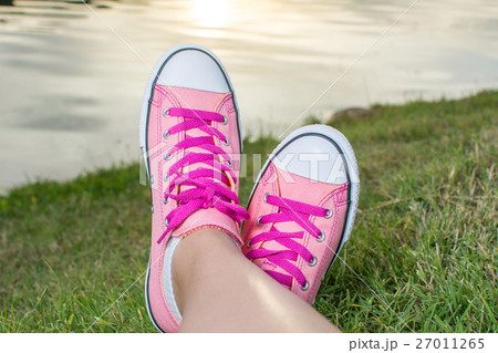 Enjoying by lake. Woman wearing pink sneakers Enjoying by lake. Woman wearing pink sneakers 27011265