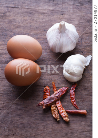 garlic chilli and egg on wooden background garlic chilli and egg on wooden background 27014977