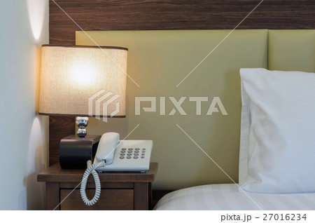 Closeup pillow on the bed with lamp in luxury hotel 27016234