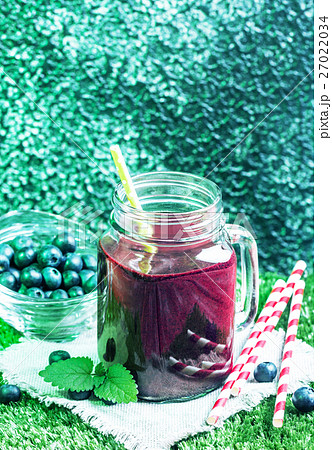 Blueberry smoothie in a glass Blueberry smoothie in a glass 27022034