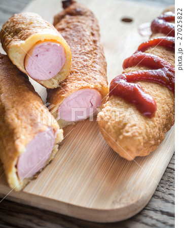 Corn dogs on the wooden board 27025822