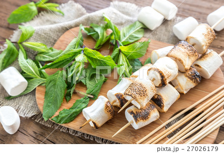 Marshmallow skewers on the wooden board 27026179