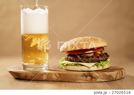 fresh homemade burger with beer on olive board fresh homemade burger with beer on olive board 27026518
