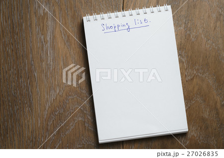 shopping list on notepad on wood table 27026835