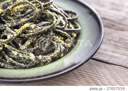 Black pasta with pesto sauce 27027550