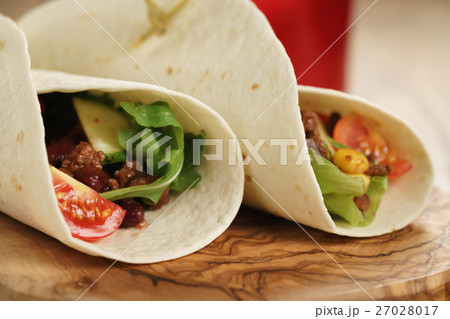 fresh homemade tortilla wrap sandwiches with beef and vegetables on olive board fresh homemade tortilla wrap sandwiches with beef and vegetables on olive board 27028017