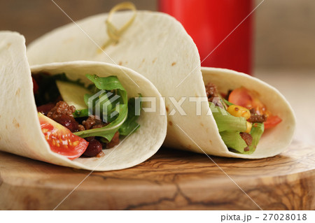 fresh homemade tortilla wrap sandwiches with beef and vegetables on olive board fresh homemade tortilla wrap sandwiches with beef and vegetables on olive board 27028018