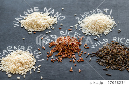 Different kinds of rice on the dark background 27028234