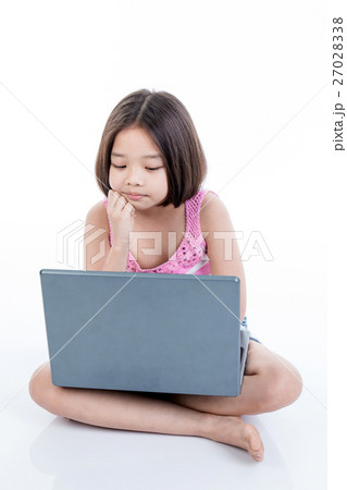 Asian child girl using laptop and thinking Asian child girl using laptop and thinking 27028338