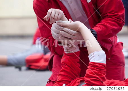 Paramedic giving help to an injured person Paramedic giving help to an injured person 27031075