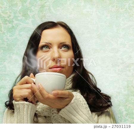 Woman in warm scarf with hot drink 27031119