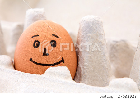 Smiling egg in a carton box 27032928