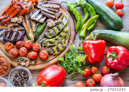 Grilled and fresh vegetables on the wooden board Grilled and fresh vegetables on the wooden board 27033283