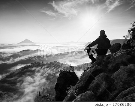 Hiker man take a rest on mountain peak. Man lay  27036280