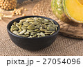 Green pumpkin seeds peeled in a black cup 27054096