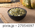 Green pumpkin seeds peeled in a black cup 27054097