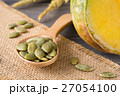 Green pumpkin seeds in a wooden spoon 27054100