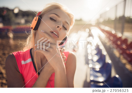 Young beautiful woman with headphones posing over 27056325