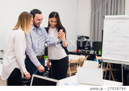 Group of four diverse cheerful co-workers taking 27058784