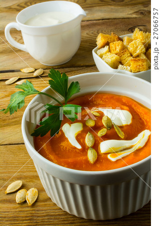Pumpkin soup with cream on dark wooden background 27066757