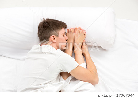 The young lovely couple lying in a bed 27067044