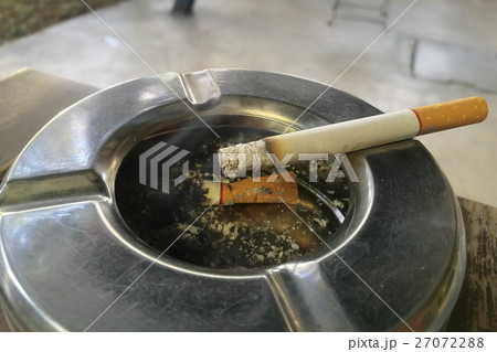 smoking a cigarette, cigarette in hand, ashtray 27072288
