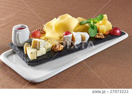 Delicious cheese plate on a restaurant table Delicious cheese plate on a restaurant table 27073221