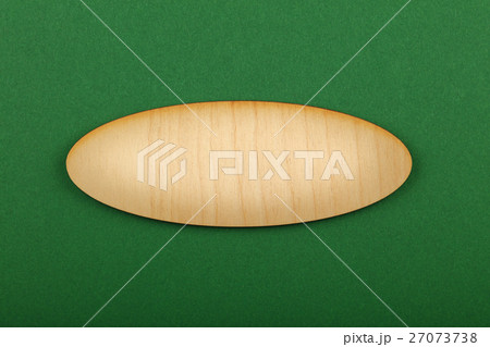 Ellipse shaped wooden sign on green background 27073738