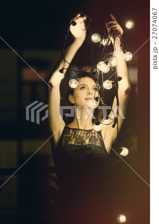 young woman with fairy lights young woman with fairy lights 27074067