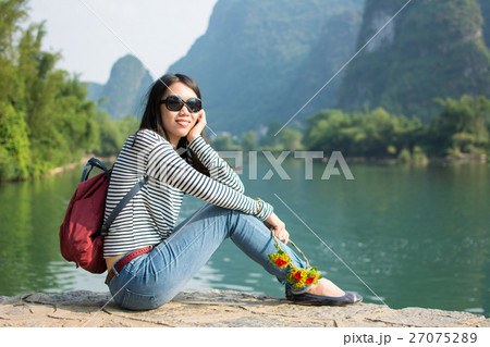 Girl sitting in the karst nature scenic area Girl sitting in the karst nature scenic area 27075289